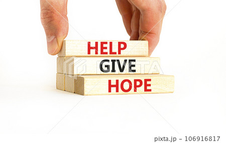 Help give hope symbol. Concept word Help give hope on beautiful wooden block. Businessman hand. Beautiful white table white background. Business motivational help give hope concept. Copy space. 106916817