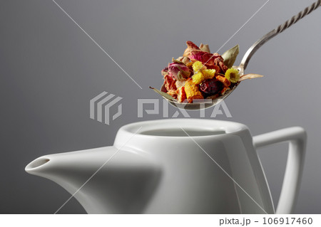 The mix of dried herbs and flowers is poured into the teapot. The mix of dried herbs and flowers is poured into the teapot. 106917460