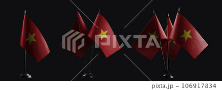 Small national flags of the Vietnam on a black background Small national flags of the Vietnam on a black background 106917834