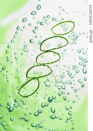 Aloe vera slice texture with gel on green background. Medicinal plant. Flat lay. Top view. Natural herbal medical plant, skincare, healthcare and beauty spa concept. Aloe vera slice texture with gel on green background. Medicinal plant. Flat lay. Top view. Natural herbal medical plant, skincare, healthcare and beauty spa concept. 106918055