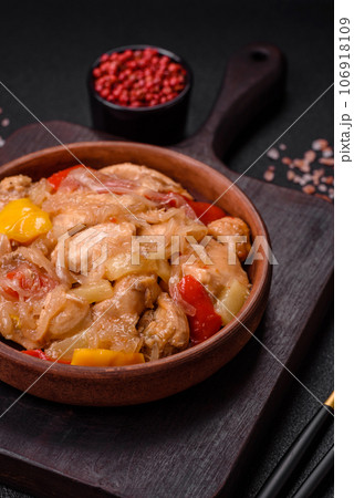 A delicious dish consisting of slices of chicken, sweet peppers and onions 106918109