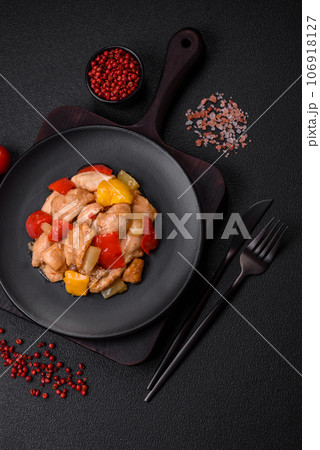 A delicious dish consisting of slices of chicken, sweet peppers and onions 106918127