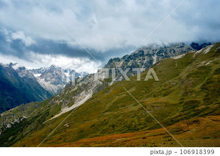 Mountain ranges on a sunny day at Georgia. Sky with clouds adn hills Mountain ranges on a sunny day at Georgia. Sky with clouds adn hills 106918399