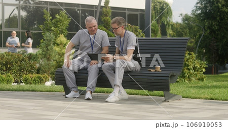 Two doctors look at tests results using tablet Two doctors look at tests results using tablet 106919053