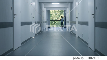Medical staff and patients in modern hospital or medical center corridor Medical staff and patients in modern hospital or medical center corridor 106919096