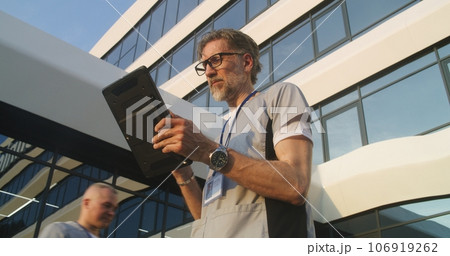 Doctor speaks with patient during online appointment using digital tablet 106919262