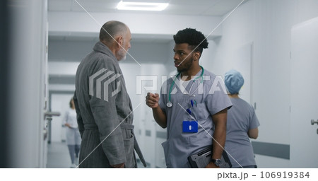 African American doctor asks elderly patient about his health 106919384