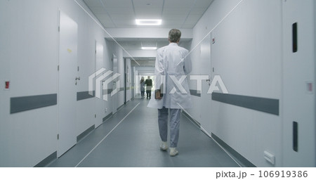 Professional medic stops to talk to colleague and old patient 106919386