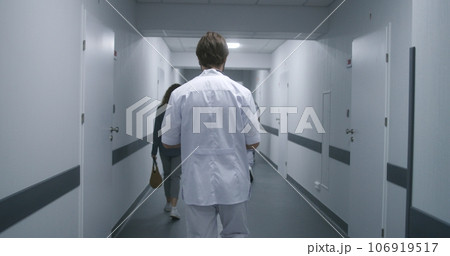 Doctor in white uniform walks medical center Doctor in white uniform walks medical center 106919517