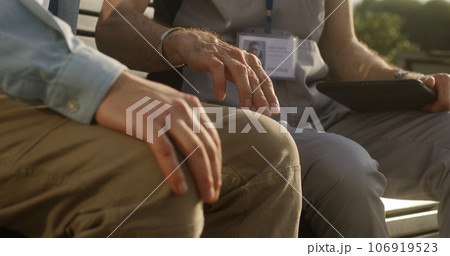 Man touches leg and complains of pain to doctor Man touches leg and complains of pain to doctor 106919523