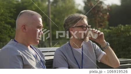 Two male doctors drink coffee before start of work 106919526