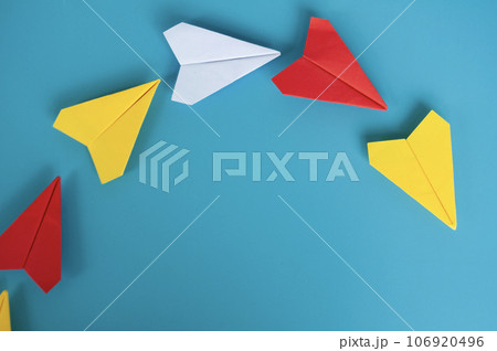 Top view of yellow paper airplane origami leading other paper airplanes. Top view of yellow paper airplane origami leading other paper airplanes. 106920496