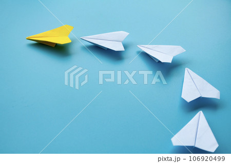 Side view of yellow paper airplane origami leading white paper airplanes. Leadership concept Side view of yellow paper airplane origami leading white paper airplanes. Leadership concept 106920499
