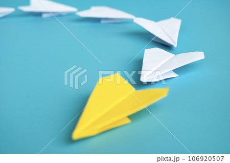 Low view of yellow paper plane origami leading white paper planes. With copy space for text. 106920507