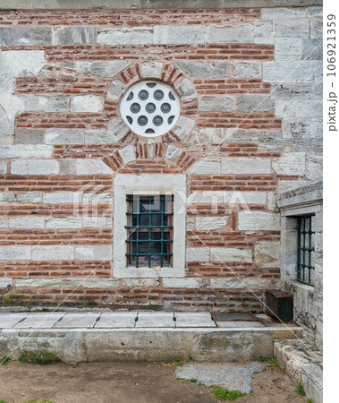 Red brick wall with a barred window, Semsi Pasha Mosque, located in the district of Uskudar, Istanbul, Turkey 106921359