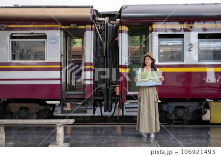 Asian woman traveler with backpack and sunglass looking the map with train background at train station concept transportation backpacker tourist lifestyle active journey and travel adventure trip Asian woman traveler with backpack and sunglass looking the map with train background at train station concept transportation backpacker tourist lifestyle active journey and travel adventure trip 106921493