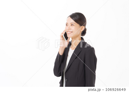 スマホで話すスーツの女性 106926649