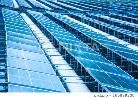 Side view of solar panels floating on water in a lake, for generating electricity from sunlight, selective focus, soft focus. Side view of solar panels floating on water in a lake, for generating electricity from sunlight, selective focus, soft focus. 106929500