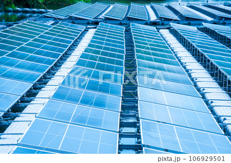 Side view of solar panels floating on water in a lake, for generating electricity from sunlight, selective focus, soft focus. Side view of solar panels floating on water in a lake, for generating electricity from sunlight, selective focus, soft focus. 106929501