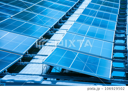 Side view of solar panels floating on water in a lake, for generating electricity from sunlight, selective focus, soft focus. Side view of solar panels floating on water in a lake, for generating electricity from sunlight, selective focus, soft focus. 106929502