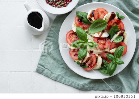 Caprese salad with tomatoes, mozzarella and basil. Caprese salad with tomatoes, mozzarella and basil. 106930351
