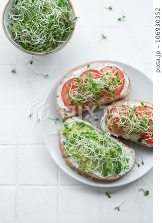 Healthy Eating. Sandwiches with tomatoes, avocado and microgreens. 106930352