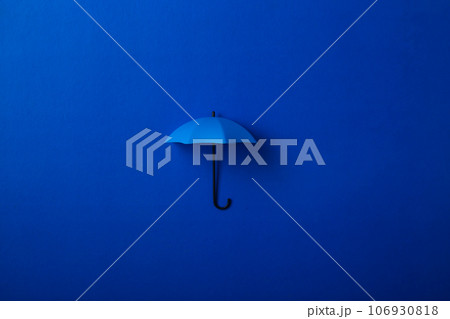 Blue umbrella isolated on purple background. 106930818