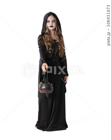 Halloween witch girl with cauldron of sweets 106931873