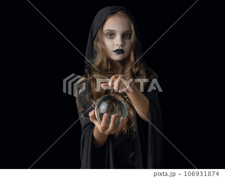 Halloween witch girl with crystal ball 106931874