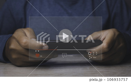 Man playing video game on his mobile phone. Online movie streaming with smartphone. 106933757