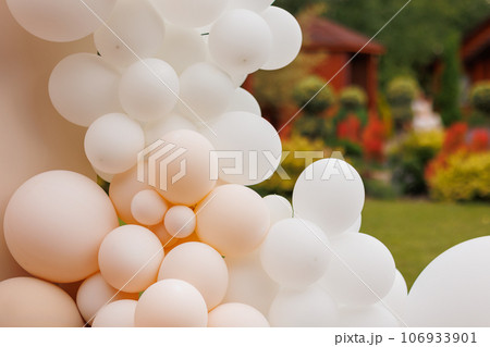 Various air balloons of different pastel colours and sizes. Details of creative gender neutral babyshower or birthday party decoration outdoors. Festive photo zone arch kit Various air balloons of different pastel colours and sizes. Details of creative gender neutral babyshower or birthday party decoration outdoors. Festive photo zone arch kit 106933901
