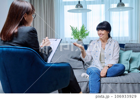 Mature woman at therapy meeting with psychologist Mature woman at therapy meeting with psychologist 106933929