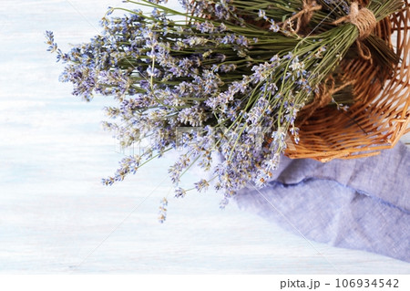 Bouquets of lavender flowers in a wicker basket on a wooden table, top view Bouquets of lavender flowers in a wicker basket on a wooden table, top view 106934542
