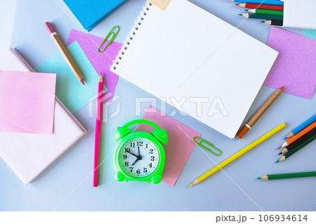 Back to school, alarm clock, colorful sticky notes and colorful pencils, drawing supplies on gray background with copy space, top view, flatly Back to school, alarm clock, colorful sticky notes and colorful pencils, drawing supplies on gray background with copy space, top view, flatly 106934614