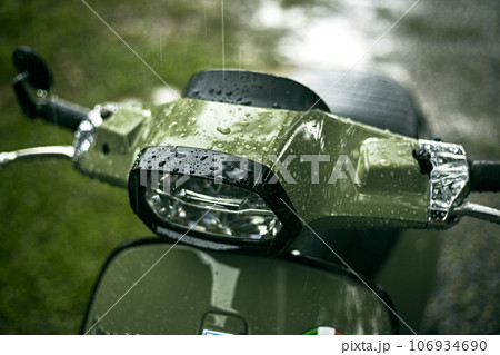 Close up green motorcycle scooter with raindrops Close up green motorcycle scooter with raindrops 106934690