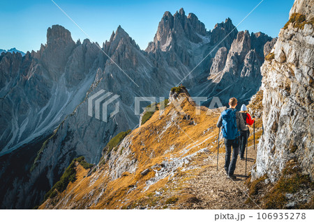 Famous hiking trail with hikers in the Dolomites, Italy 106935278