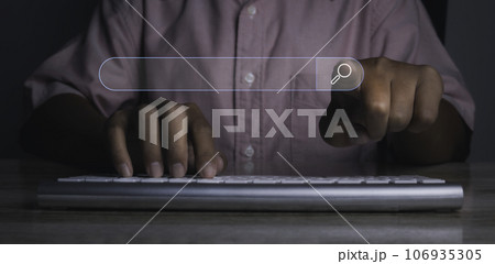Man presses the information search button on computer virtual screen. Man presses the information search button on computer virtual screen. 106935305