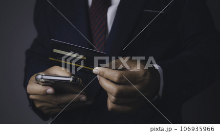 Businessman using mobile phone and credit card shopping online. 106935966