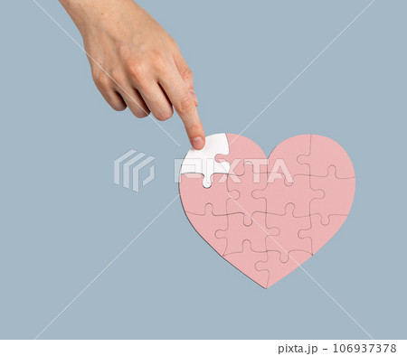 Adding the missing puzzle piece to heart-shaped jigsaw. Help, aid, donation concept Adding the missing puzzle piece to heart-shaped jigsaw. Help, aid, donation concept 106937378