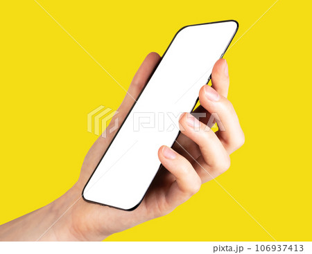 Hand holding smart phone mockup, mobile screen mock up on yellow background 106937413