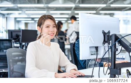 フリーアドレスのオフィスで仕事をする女性 106937724