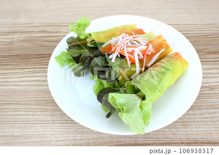 Crab stick salad roll in white dish on the table 106938317
