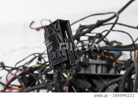 A modern car connector or trailer for closing an electrical circuit that a mechanic holds in gloves during repairs. A modern car connector or trailer for closing an electrical circuit that a mechanic holds in gloves during repairs. 106940221