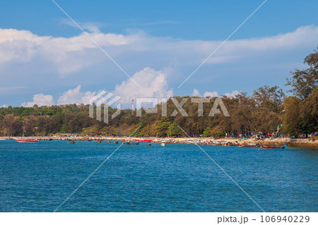 Rawai beach in thailand on the island of phuket with old fishing wooden boats with long ropes moored to the shore. Rawai beach in thailand on the island of phuket with old fishing wooden boats with long ropes moored to the shore. 106940229