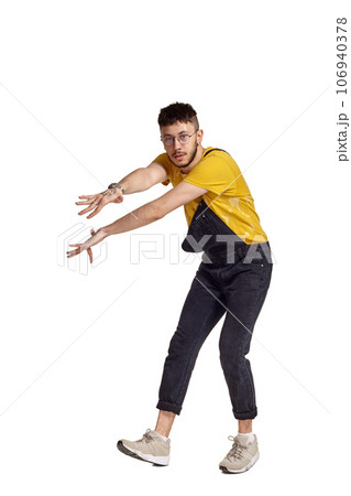 Full-length portrait of a funny guy dancing in studio isolated on white background. Full-length portrait of a funny guy dancing in studio isolated on white background. 106940378