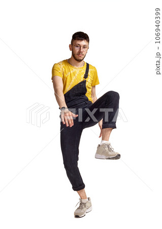 Full-length portrait of a funny guy dancing in studio isolated on white background. Full-length portrait of a funny guy dancing in studio isolated on white background. 106940399