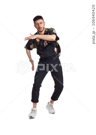 Full-length portrait of a funny guy dancing in studio isolated on white background. 106940420