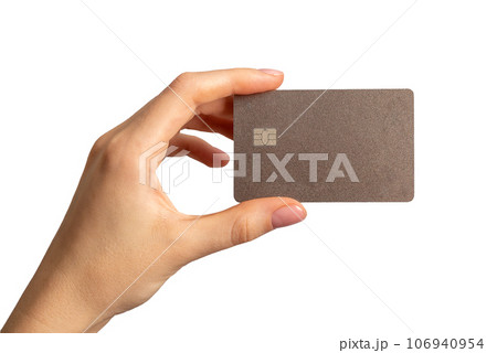 Hand holding bank card mock up, plastic with chip, isolated on white background 106940954