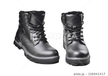 Winter mens black leather boots on a white background, hiking shoes, practical off-road shoes, close-up 106941417