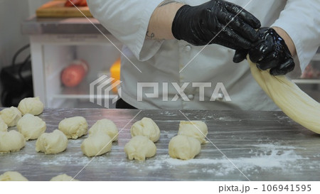 Bakery, the chef is preparing the dough, the bakery worker is preparing the dough, the cook is working with the dough in the kitchen, the cook's cookies are molding the dough for the bakery. Bakery, the chef is preparing the dough, the bakery worker is preparing the dough, the cook is working with the dough in the kitchen, the cook's cookies are molding the dough for the bakery. 106941595